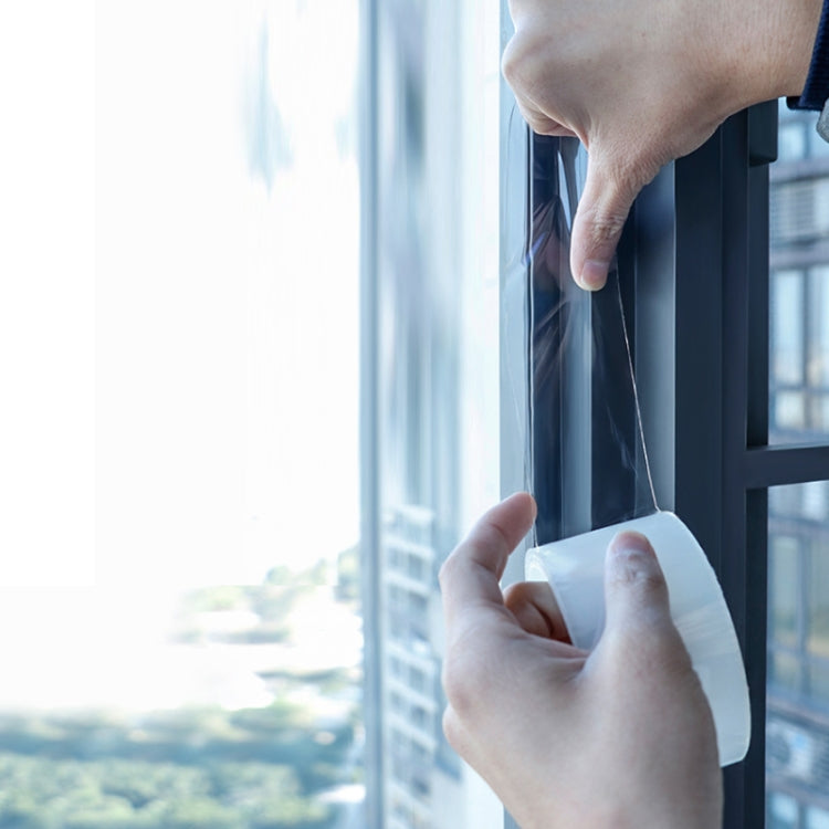 Hands pressing white gap sealing tape onto a window frame for a tight seal