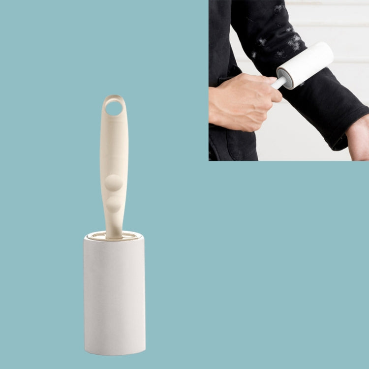 Long handle sticky lint roller with apricot handle and white adhesive paper refill base.