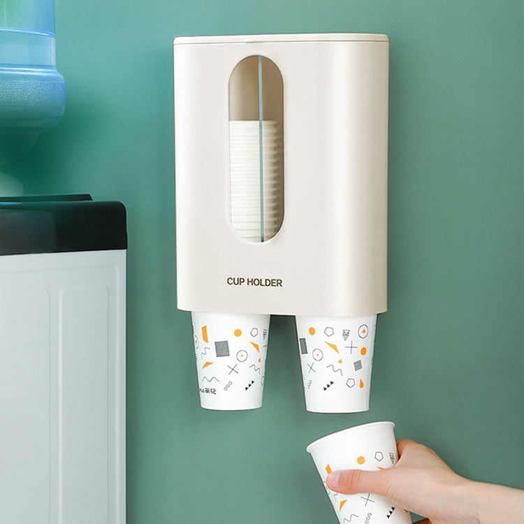 Wall-mounted disposable cup dispenser, white with cup stacks visible through oval window