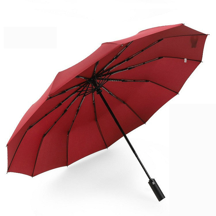Red automatic double-folding umbrella with black frame and strap handle