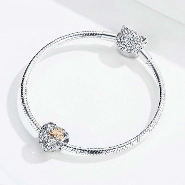 Snake bracelet with heart-shaped charm bead and rose gold clover center CZ sparkle details.