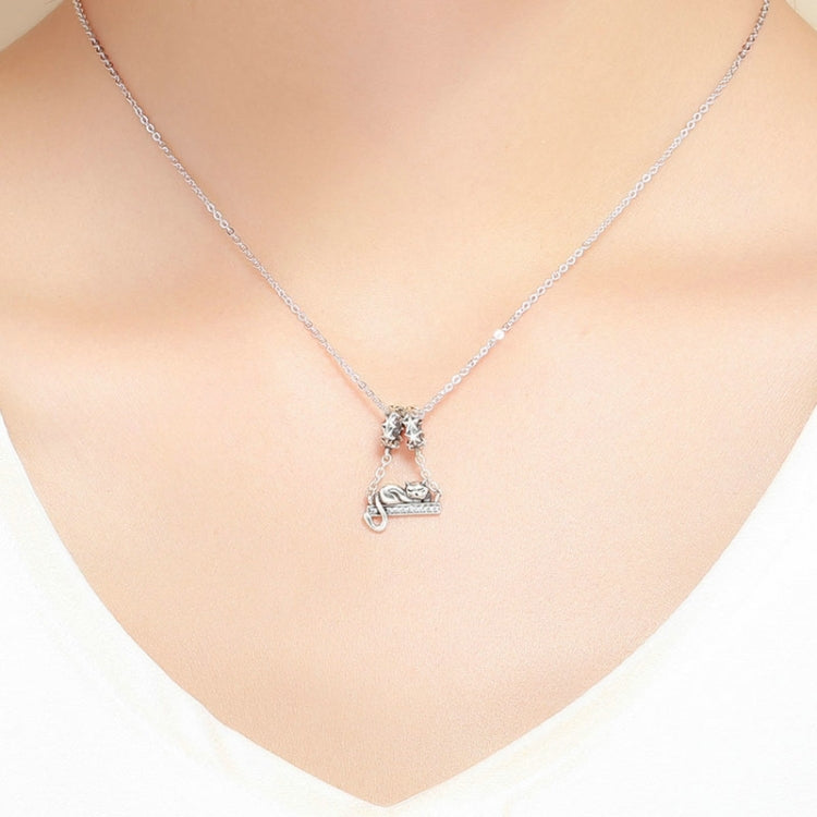 Sterling silver cat necklace pendant hanging from a fine chain on neckline