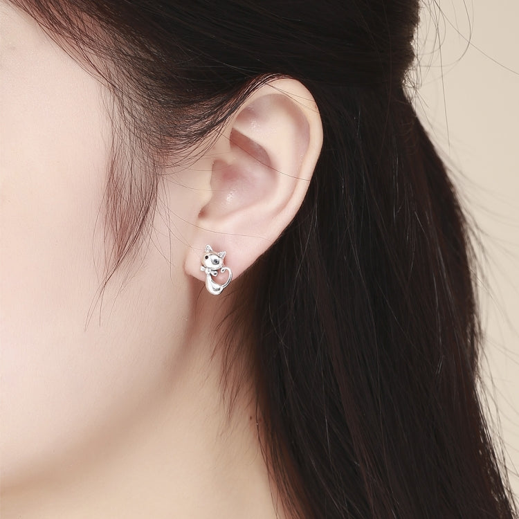 Wearing cat-shaped 925 sterling silver stud earrings with small CZ eyes on ear