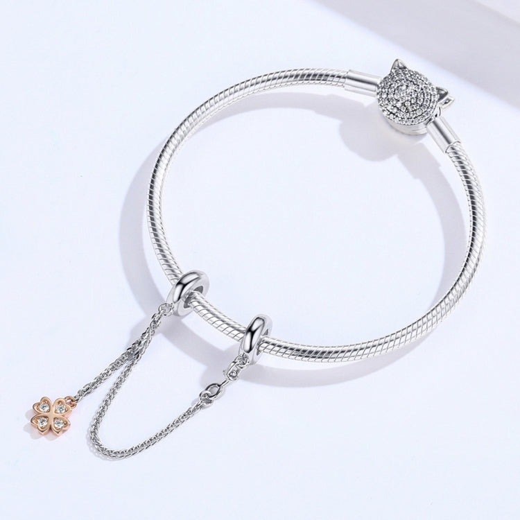 Snake-chain bracelet with plated safety chain and small clover charm pendant