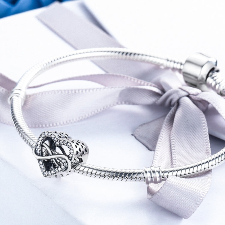 Sterling silver charm bracelet with heart-shaped hollow bead and snake chain