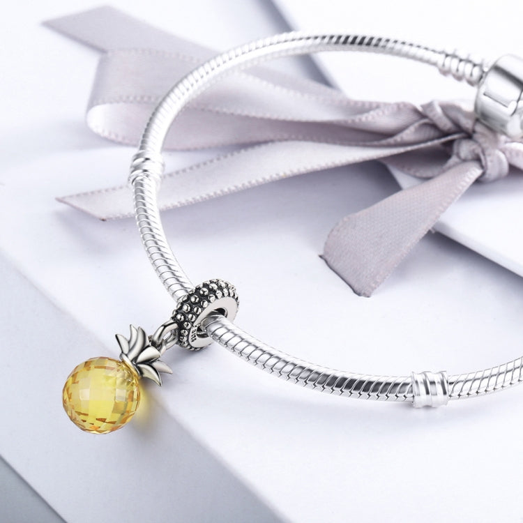 Silver bracelet charm with faceted yellow pineapple bead and textured pineapple cap