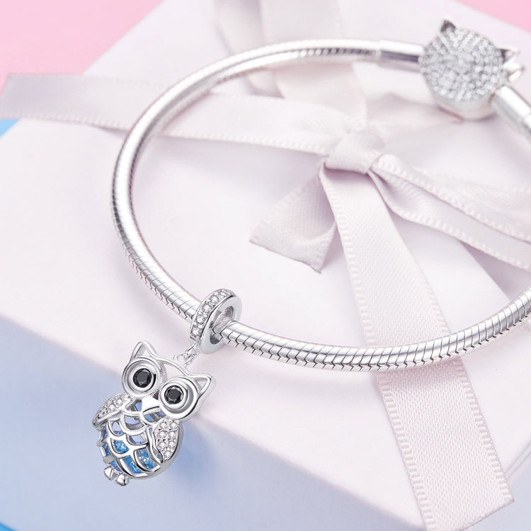 Owl charm pendant on a silver snake chain with blue enamel accents