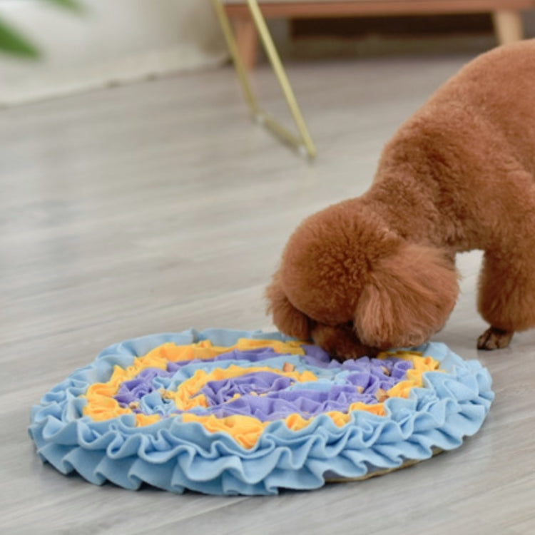 Dog sniffing mat with light blue ruffles and yellow/orange center lanes; puppy sniffing