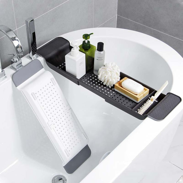 Black and white bathtub rack with perforated tray and folding side supports