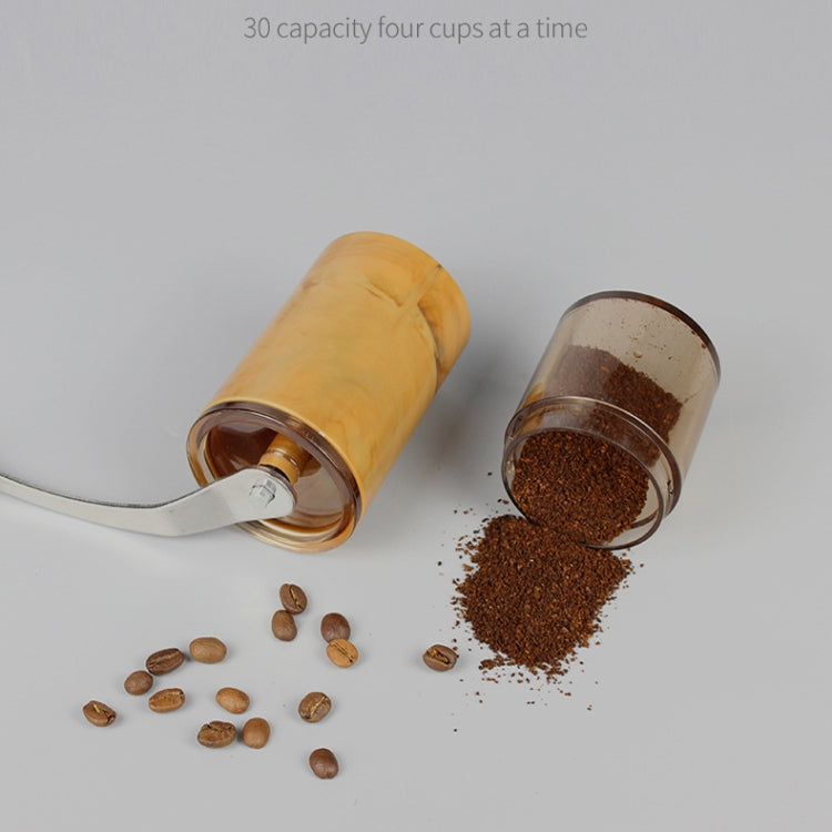 Hand-cranked coffee grinder with chute dispensing coffee grounds