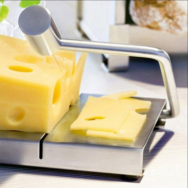 Stainless steel cheese slicer cutting board with yellow cheese slices on tray