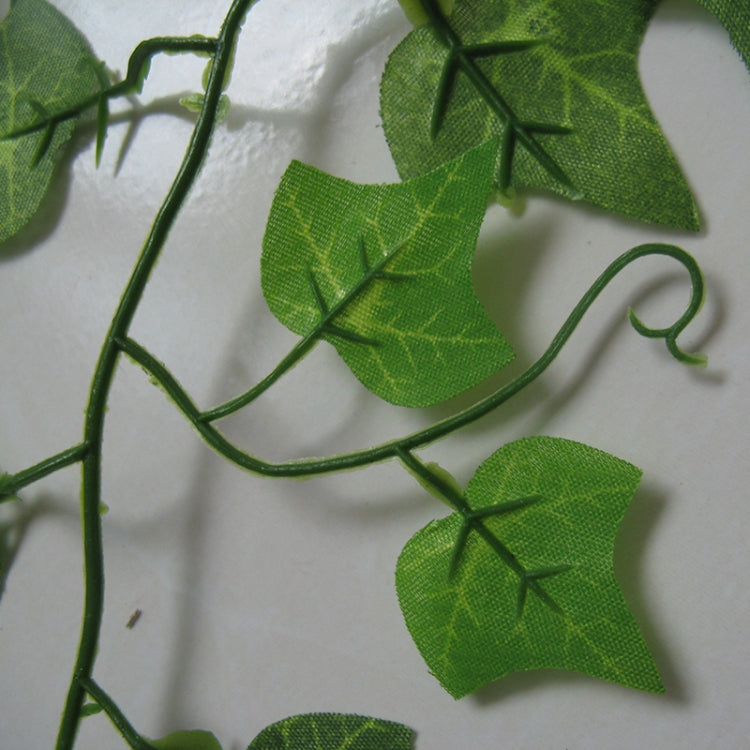 Close-up of artificial green ivy leaves on a flexible vine string
