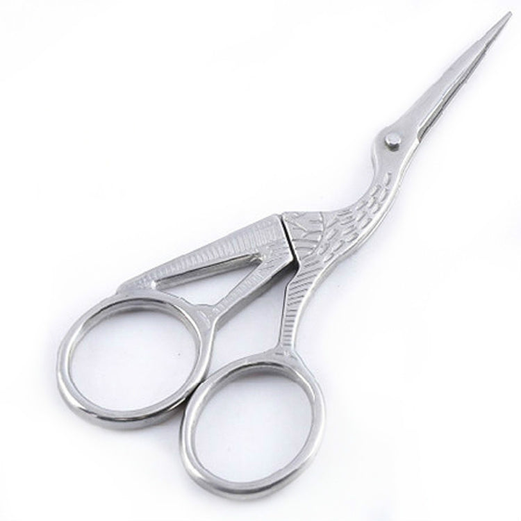 Silver-tone cross-stitch sewing scissors with pointed blades and etched finger loops