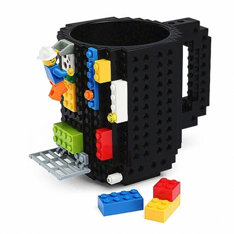 Black building block mug with studded sides and small colorful figure pieces