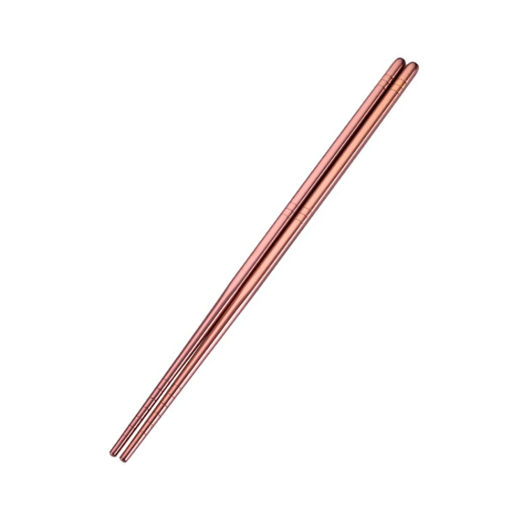 Rose gold stainless steel chopsticks, reusable pair with pointed tips.