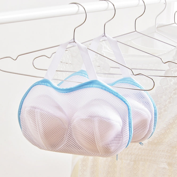 Blue mesh bra laundry bag hanging on plastic hangers, two compartments visible through mesh