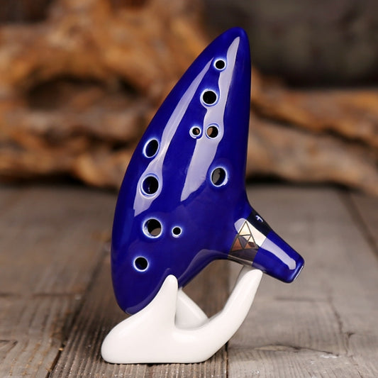 Blue 12-hole alto ocarina side view with white finger rests and key holes