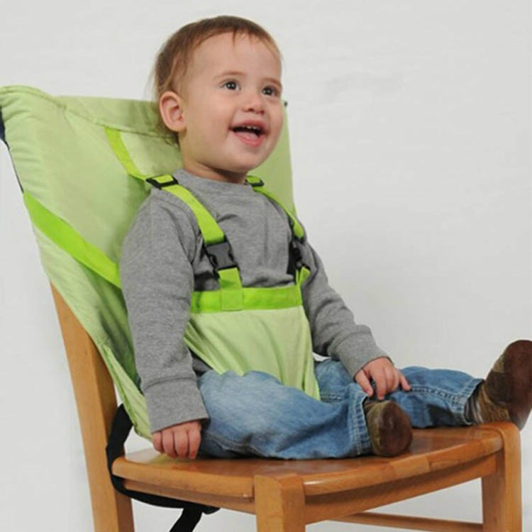 Green portable baby dining seat cover with safety belt, baby seated on chair