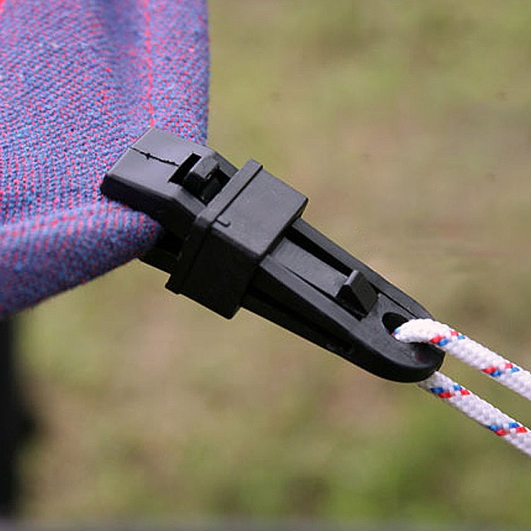 Black plastic tent rope clamp gripping braided rope with latch