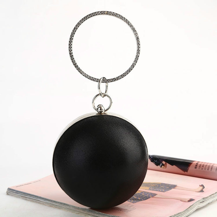 Black spherical evening bag with silver ring handle and metal clasp