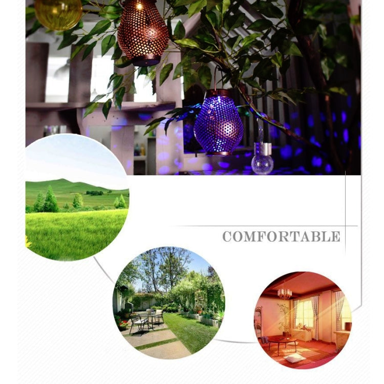 Outdoor hanging metal lantern glowing with floral cutouts