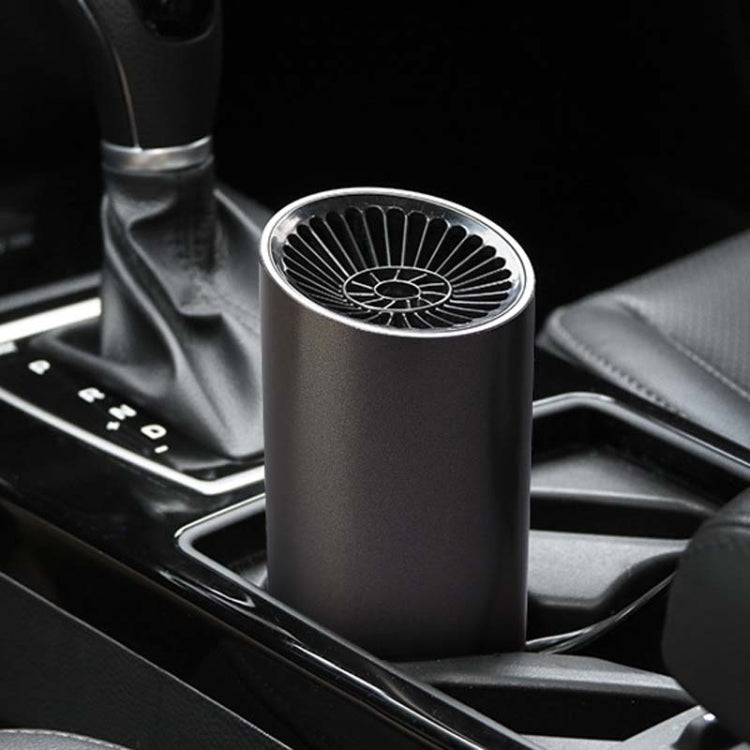 Black car cylinder heater with glowing top vent placed in car console