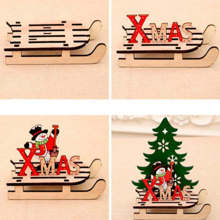 Wooden Christmas sleigh decoration close-up with curved runner and red "XMAS" letters