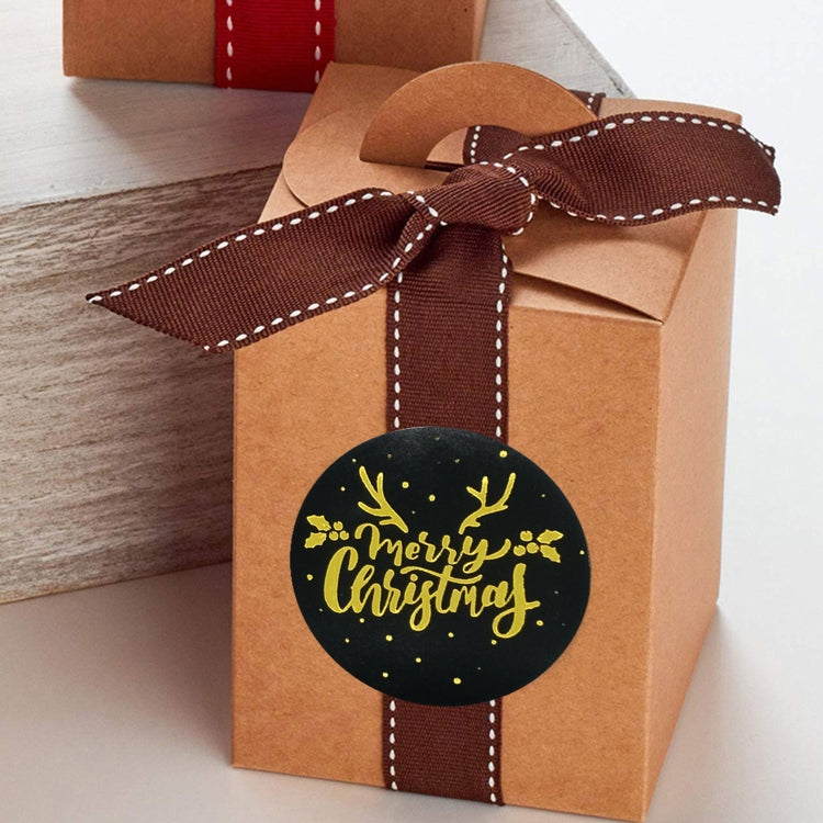 Brown gift bag sealed with black round gold "Merry Christmas" sticker