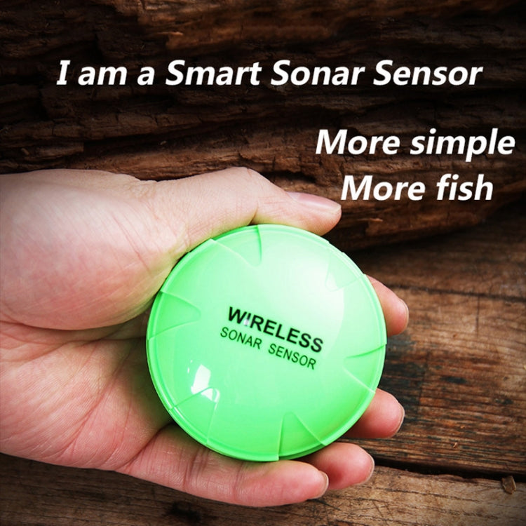 Green wireless sonar sensor held in hand on a wooden surface