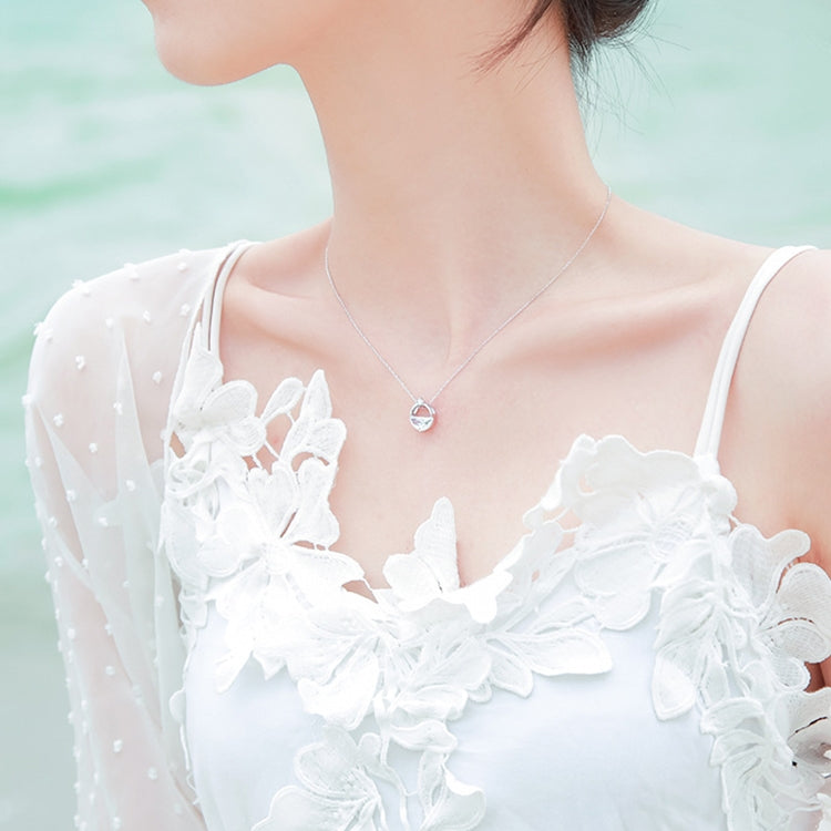 Sterling silver heart pendant necklace worn on neck with clear faceted stone