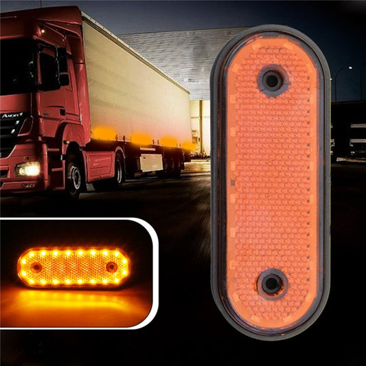 Oval LED side marker light with orange illuminated lens and black rubber outer frame