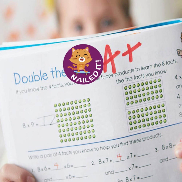 Circular 'Nailed' reward sticker on classroom worksheet with math grids