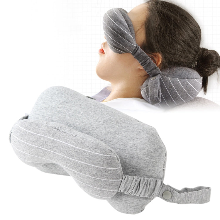 Light gray travel neck pillow with attached striped eye mask for resting