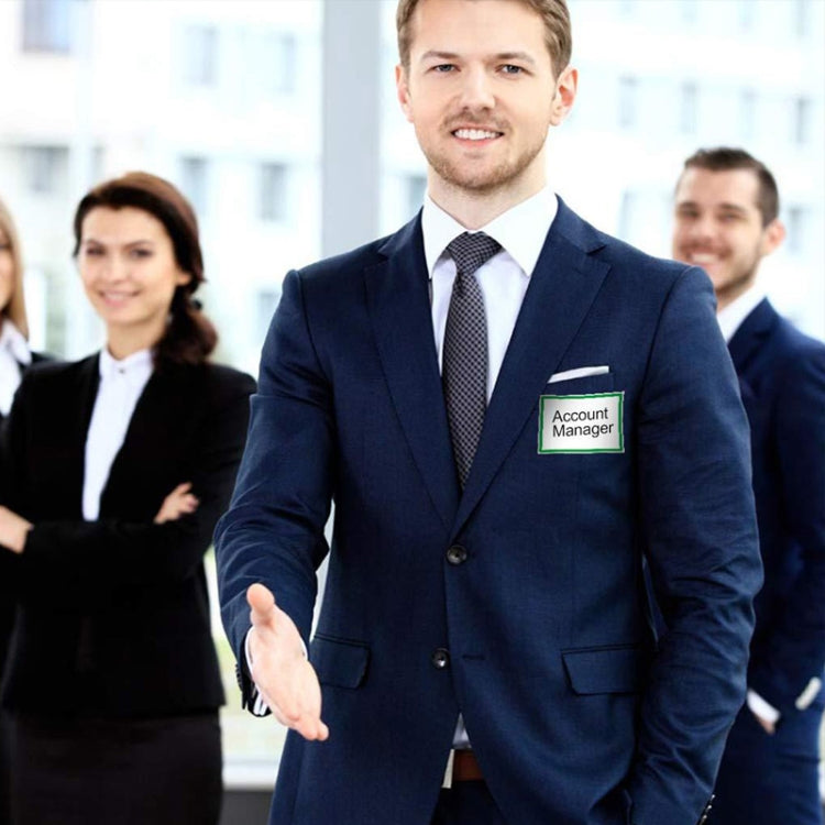 Name badge sticker on suit pocket with green border, reading 'Account Manager'