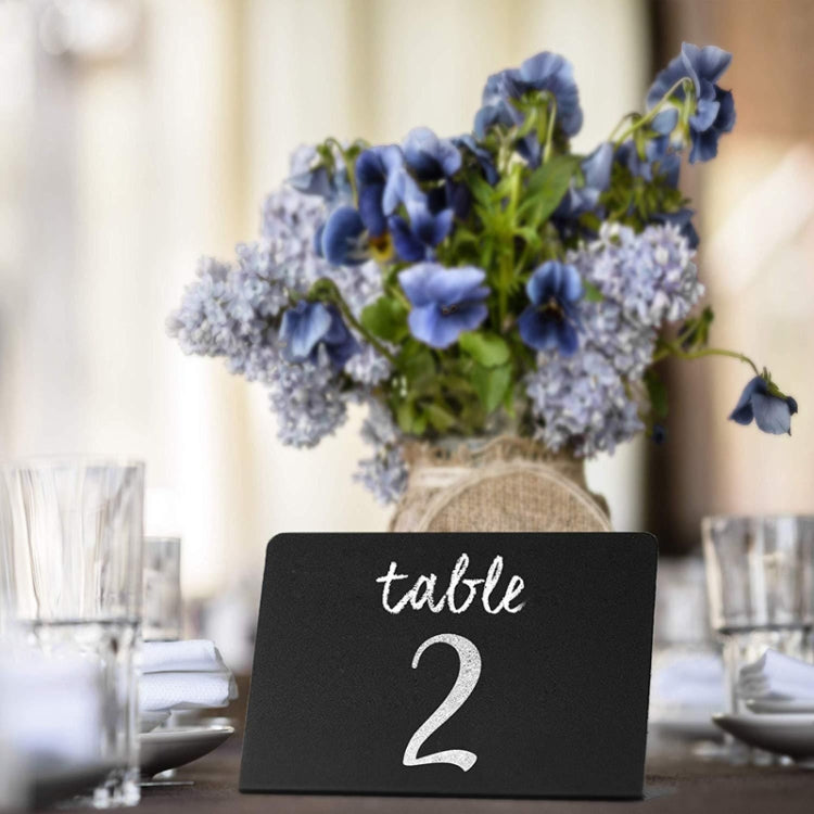 Black desktop table number board with cursive text "table 2"