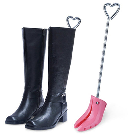 Adjustable boot shoe expander with pink foot plate and two black high-top boots