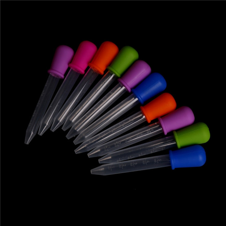 Clear plastic pipette droppers with multicolor silicone caps and angled dispensing tips