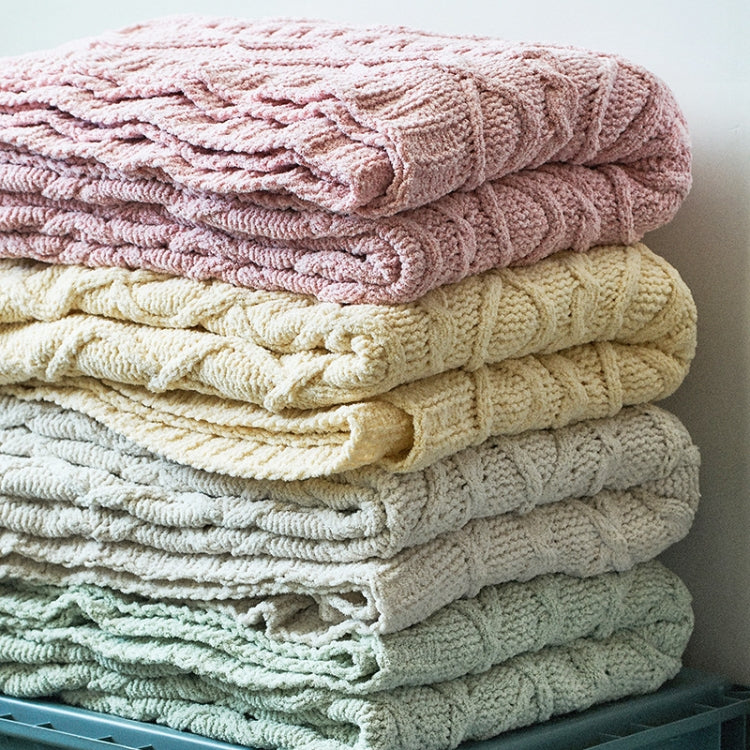 Chenille cable-knit blankets stacked, pink, cream, gray, and sage green throws