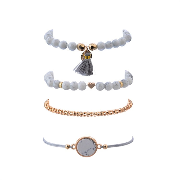 Boho bracelet set with white bead tassel bracelets, rose-gold chain bangle, and heart bead detail