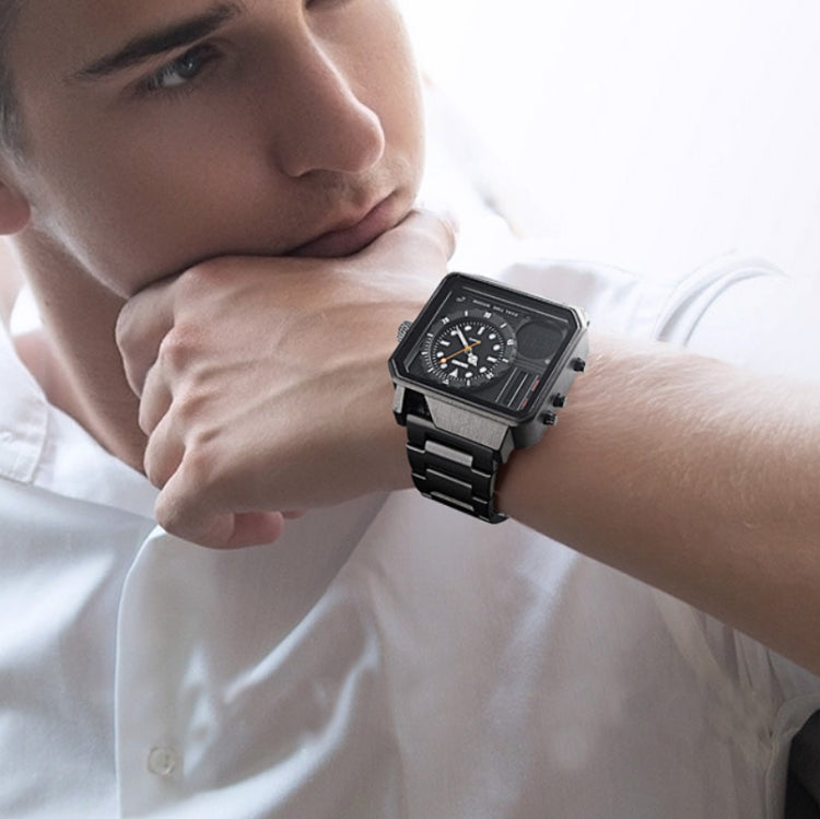Black sports watch worn on wrist with dual-display dial and metal link band