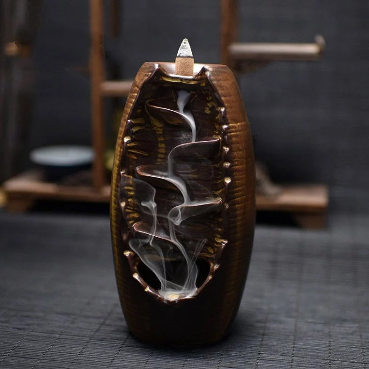 Dark brown ceramic incense burner with cone top and swirling backflow smoke