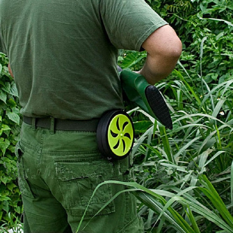 Mosquito coil holder tray clipped to a person’s waistband outdoors near grass
