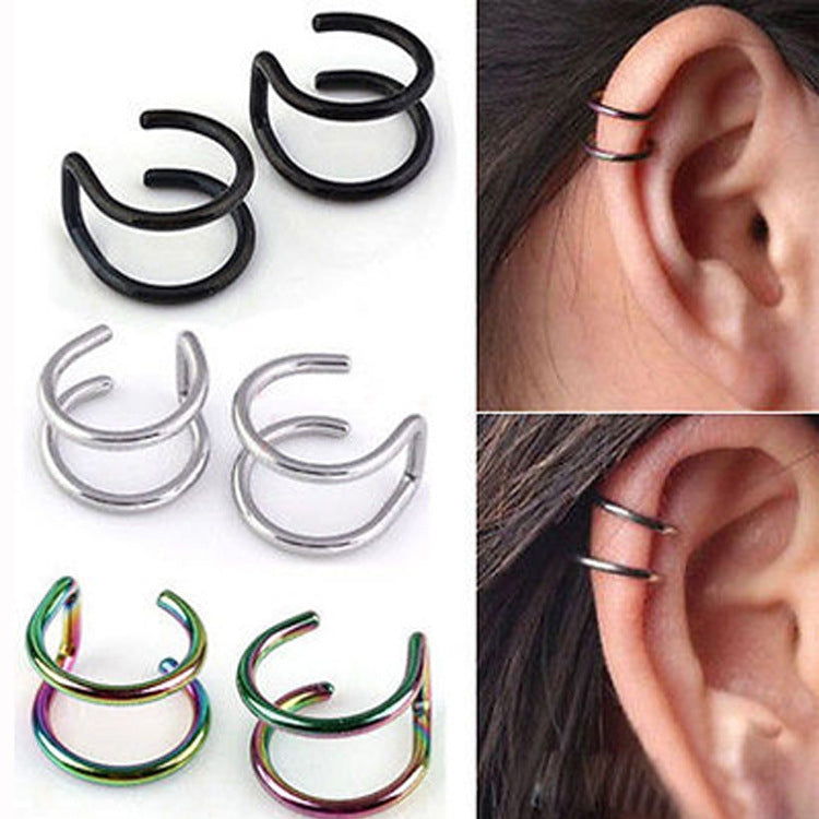 U-shape ear clip earrings set: black, silver and rainbow; one worn on an ear