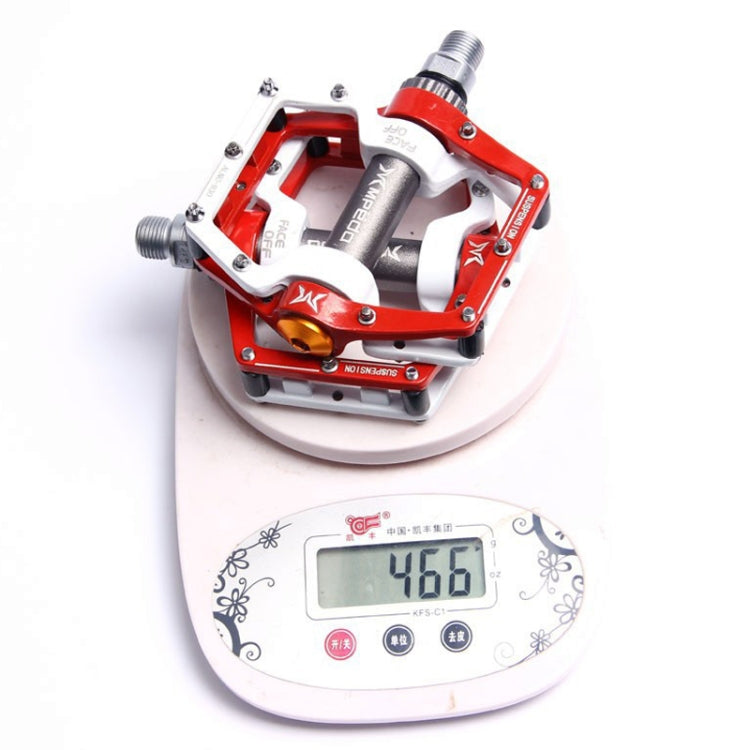 Red mountain bike bearing pedal on a digital scale