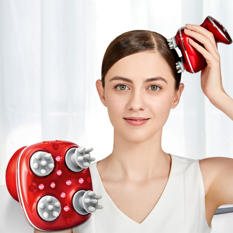 Red electric scalp massager being used on a woman’s head near the temple