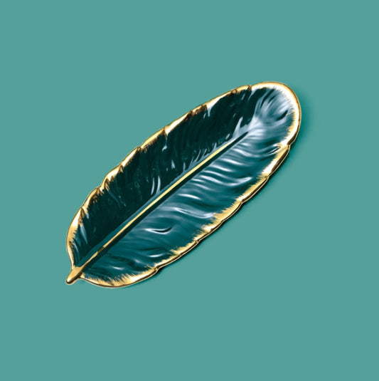 Ceramic leaf-shaped dessert plate, bright emerald green glaze with gold-edged rim.