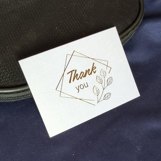 White wedding blessing card with gold “Thank you” text and leaf sprig frame