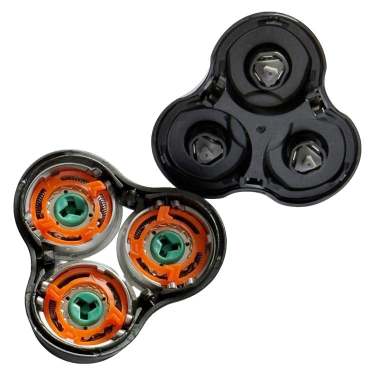 Underside razor head showing three orange gear modules with green centers