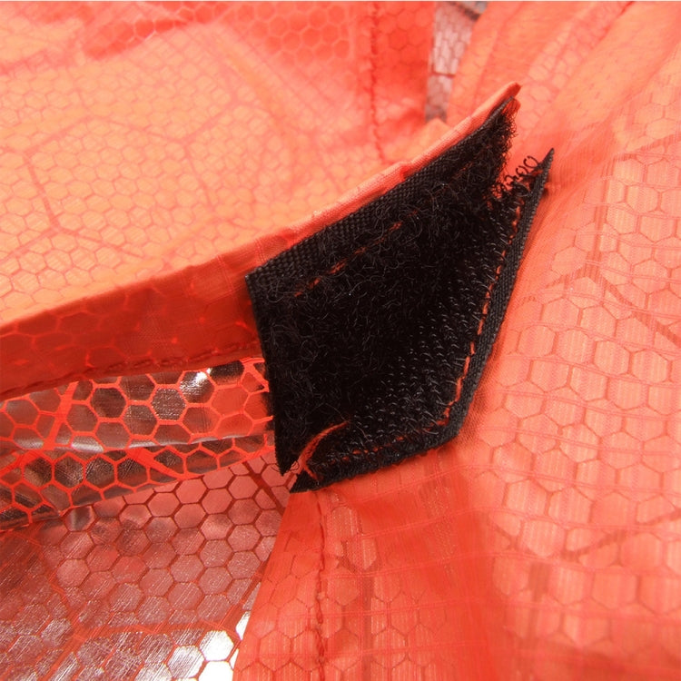 Close-up of orange heat-reflective blanket seam with black strap and silver reflective fabric
