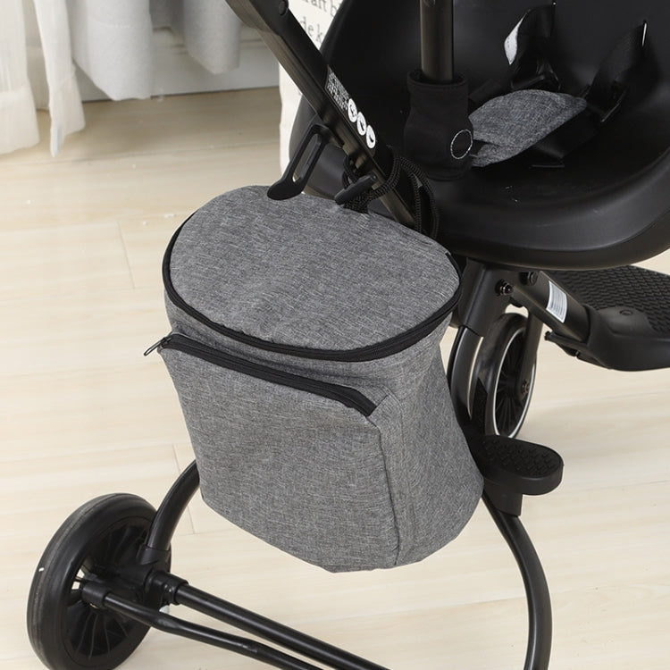 Gray stroller organizer bag attached to stroller frame with zippered lid